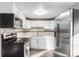 Bright kitchen featuring stainless steel appliances, white cabinets, and sleek countertops at 1050 S Raleigh St, Denver, CO 80219