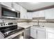 Modern kitchen featuring white cabinets, stainless steel appliances, and elegant countertops at 1050 S Raleigh St, Denver, CO 80219