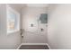 Bright laundry room with window, utility hookups, and an electrical panel at 1050 S Raleigh St, Denver, CO 80219