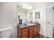 Bright bathroom with a granite countertop, a large mirror, and neutral decor at 17525 Wilde Ave # 307, Parker, CO 80134