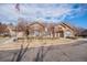 Exterior shot of the clubhouse with manicured landscaping and an American flag waving at 17525 Wilde Ave # 307, Parker, CO 80134