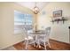 Bright dining area with hardwood floors, a round table, and a large window at 17525 Wilde Ave # 307, Parker, CO 80134