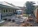 A peaceful backyard offers a stone patio set, a charming outdoor space for dining and relaxation at 7006 S Miller Ct, Littleton, CO 80127