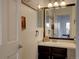 Charming bathroom with updated vanity, framed mirror, and decorative accents at 7006 S Miller Ct, Littleton, CO 80127