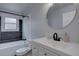 Modern bathroom features a sleek vanity, round mirror, and new fixtures at 7006 S Miller Ct, Littleton, CO 80127