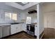 Well-lit kitchen with modern appliances, sleek countertops, and ample cabinet space at 7006 S Miller Ct, Littleton, CO 80127