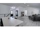 Open-concept living room featuring modern flooring, neutral tones, and ample natural light from the front door at 7006 S Miller Ct, Littleton, CO 80127