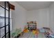 Bright playroom with gray flooring, a window, and ample space for toys and activities at 7006 S Miller Ct, Littleton, CO 80127