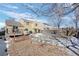 Landscaped backyard with patio, deck and winter scene at 4224 Deer Watch Dr, Castle Rock, CO 80104