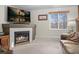 Living room with corner fireplace and large TV at 4224 Deer Watch Dr, Castle Rock, CO 80104