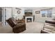 Cozy living room with a fireplace and leather furniture at 4224 Deer Watch Dr, Castle Rock, CO 80104