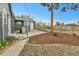 Cozy backyard featuring a grill, wood mulch, and steps up to the main house at 1000 S Perry St, Denver, CO 80219