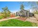 Quaint backyard featuring a stone walkway, lush lawn, and well-maintained landscaping at 1000 S Perry St, Denver, CO 80219