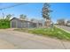 View of the fenced backyard, garage, and alley, offering a spacious outdoor area at 1000 S Perry St, Denver, CO 80219