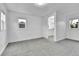 Sunlit bedroom with neutral carpet and view to kitchen through doorway at 1000 S Perry St, Denver, CO 80219