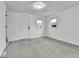 Bedroom with neutral carpet, two windows, and modern light fixture at 1000 S Perry St, Denver, CO 80219