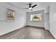 Comfortable bedroom with laminate flooring, new paint, modern fan and two windows at 1000 S Perry St, Denver, CO 80219