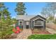 Charming front exterior with stone pathway, modern paint, and inviting red Adirondack chairs at 1000 S Perry St, Denver, CO 80219
