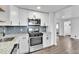 Updated kitchen featuring stainless steel appliances, granite countertops and subway tile backsplash at 1000 S Perry St, Denver, CO 80219