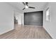 Open living room featuring laminate flooring, new paint, and access to the kitchen at 1000 S Perry St, Denver, CO 80219