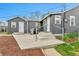 Rear exterior featuring a concrete patio, BBQ grill, and fenced yard at 1000 S Perry St, Denver, CO 80219