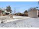 Backyard with storage shed and patio, covered in snow at 420 Racine St, Aurora, CO 80011