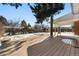 Wooden deck and backyard with storage shed and snow at 420 Racine St, Aurora, CO 80011