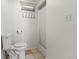 Clean basement bathroom, shower stall, toilet and small vanity at 420 Racine St, Aurora, CO 80011