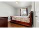 Bedroom with hardwood floors and a wooden sleigh bed at 420 Racine St, Aurora, CO 80011