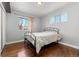 Bright bedroom with hardwood floors and a metal bed frame at 420 Racine St, Aurora, CO 80011