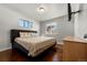 Main bedroom with hardwood floors, large bed, and window at 420 Racine St, Aurora, CO 80011