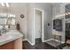 Sleek bathroom showcasing double sinks, a walk-in shower with glass door, and modern fixtures at 3383 Willowrun Dr, Castle Rock, CO 80109