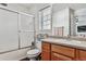 Functional bathroom featuring a shower-tub combo, toilet, and wood vanity with sink at 3383 Willowrun Dr, Castle Rock, CO 80109