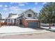 Charming two-story home features brick accents, blue siding, and a well-maintained front yard at 3383 Willowrun Dr, Castle Rock, CO 80109