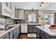 Stylish kitchen with modern appliances, gray cabinetry, and a tiled backsplash at 3383 Willowrun Dr, Castle Rock, CO 80109