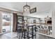 Bright kitchen area with a bar table and chairs, plus views of the living room at 3383 Willowrun Dr, Castle Rock, CO 80109