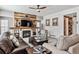 Relaxing living room features a wood-paneled fireplace, comfortable seating, and natural light at 3383 Willowrun Dr, Castle Rock, CO 80109