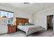 Bright main bedroom features a large window, wood headboard, and neutral tones at 3383 Willowrun Dr, Castle Rock, CO 80109