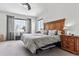 Comfortable main bedroom features a large window, wood headboard, and ample natural light at 3383 Willowrun Dr, Castle Rock, CO 80109