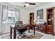 Bright home office featuring a wooden desk, ceiling fan, and decorative bookshelves at 3383 Willowrun Dr, Castle Rock, CO 80109