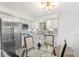 Bright kitchen featuring stainless steel appliances, white cabinetry, and cozy dining nook at 1772 S Pierce St, Lakewood, CO 80232