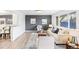 Sunlit living room featuring stylish furniture, soft rug, and large window at 1772 S Pierce St, Lakewood, CO 80232