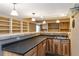Basement bar featuring countertop seating and built in shelving at 2828 Shadow Dance Dr, Castle Rock, CO 80109