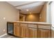 Basement bar with tile countertops and a wine fridge at 2828 Shadow Dance Dr, Castle Rock, CO 80109