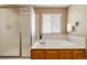 Bright bathroom with a tub and a walk-in shower at 2828 Shadow Dance Dr, Castle Rock, CO 80109