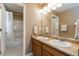 Bathroom with double sinks, a large mirror and a tub at 2828 Shadow Dance Dr, Castle Rock, CO 80109