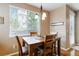 Dining area featuring wood table and chairs with a view from the window, creating a cozy atmosphere at 2828 Shadow Dance Dr, Castle Rock, CO 80109