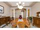 Dining room featuring hardwood table, buffet, and decorative columns at 2828 Shadow Dance Dr, Castle Rock, CO 80109
