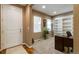 Home office near front entrance with neutral colors, a built-in bookcase and a large window for natural light at 2828 Shadow Dance Dr, Castle Rock, CO 80109