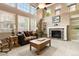 Bright living room with high ceilings, large windows, fireplace, and neutral carpet, offering comfortable living space at 2828 Shadow Dance Dr, Castle Rock, CO 80109